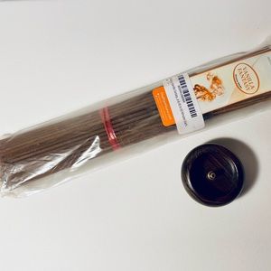 Bundle of new vanilla incense sticks with hand made wooden holder
